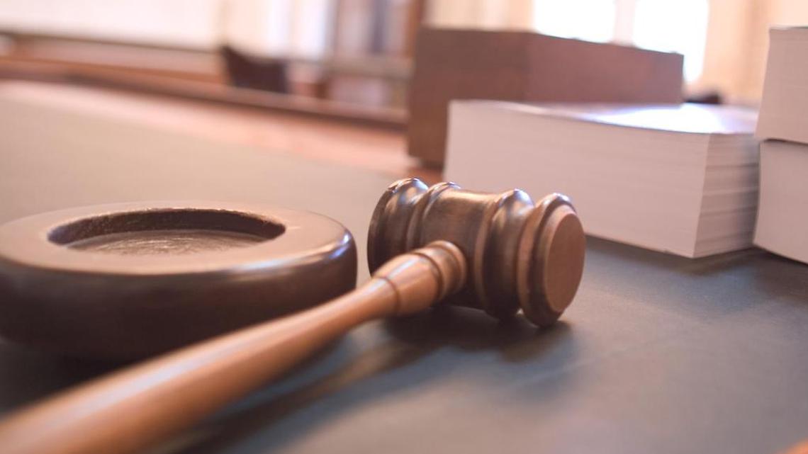 File photo of court documents and a gavel on a desk.