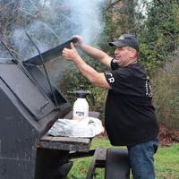 Volunteers from Harvest Church and Bigger Vision host charity barbecue to serve meals to homeless community at Athens, Georgia, shelter